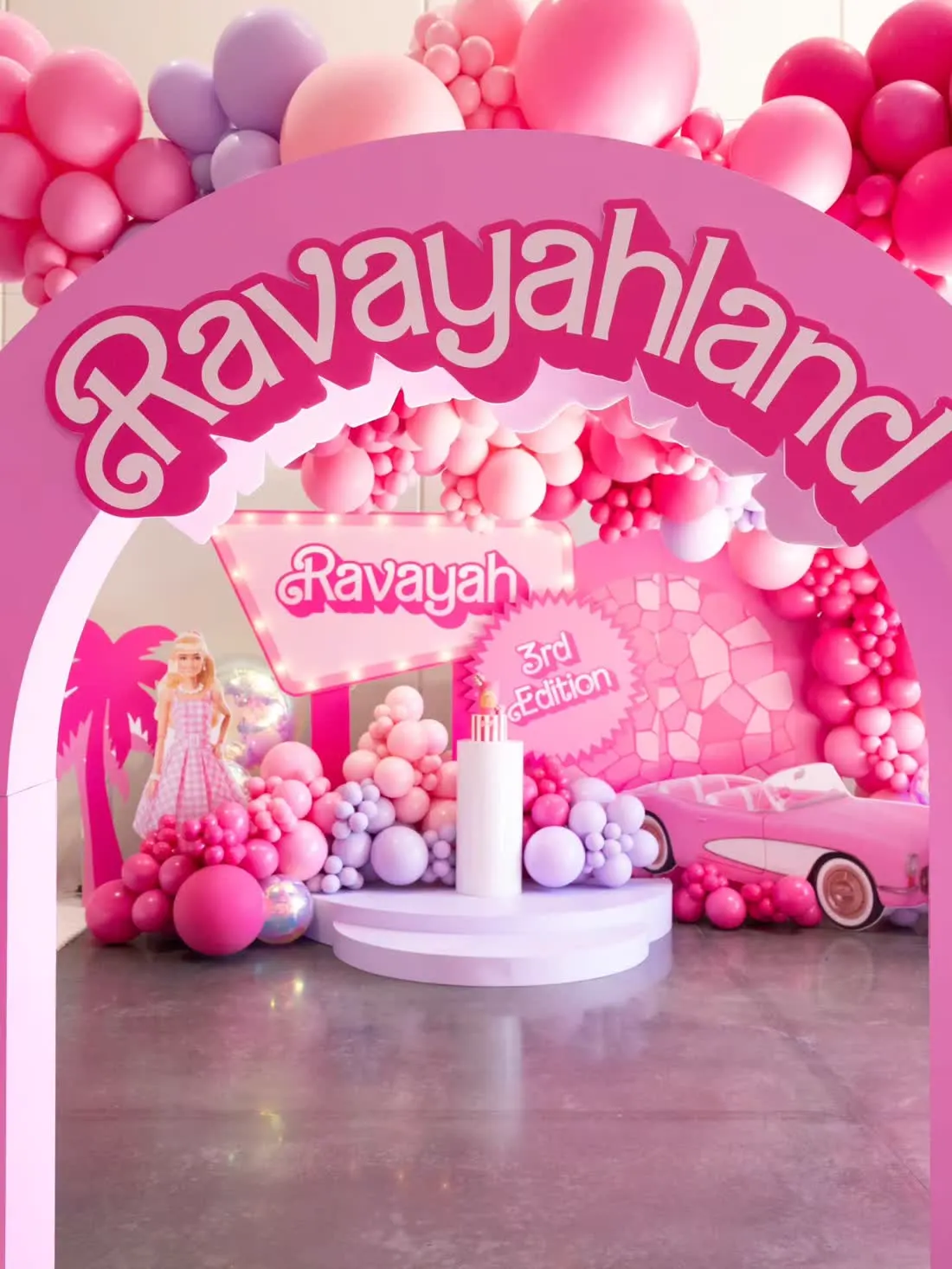 Pink themed birthday backdrop with balloon garland and cutouts