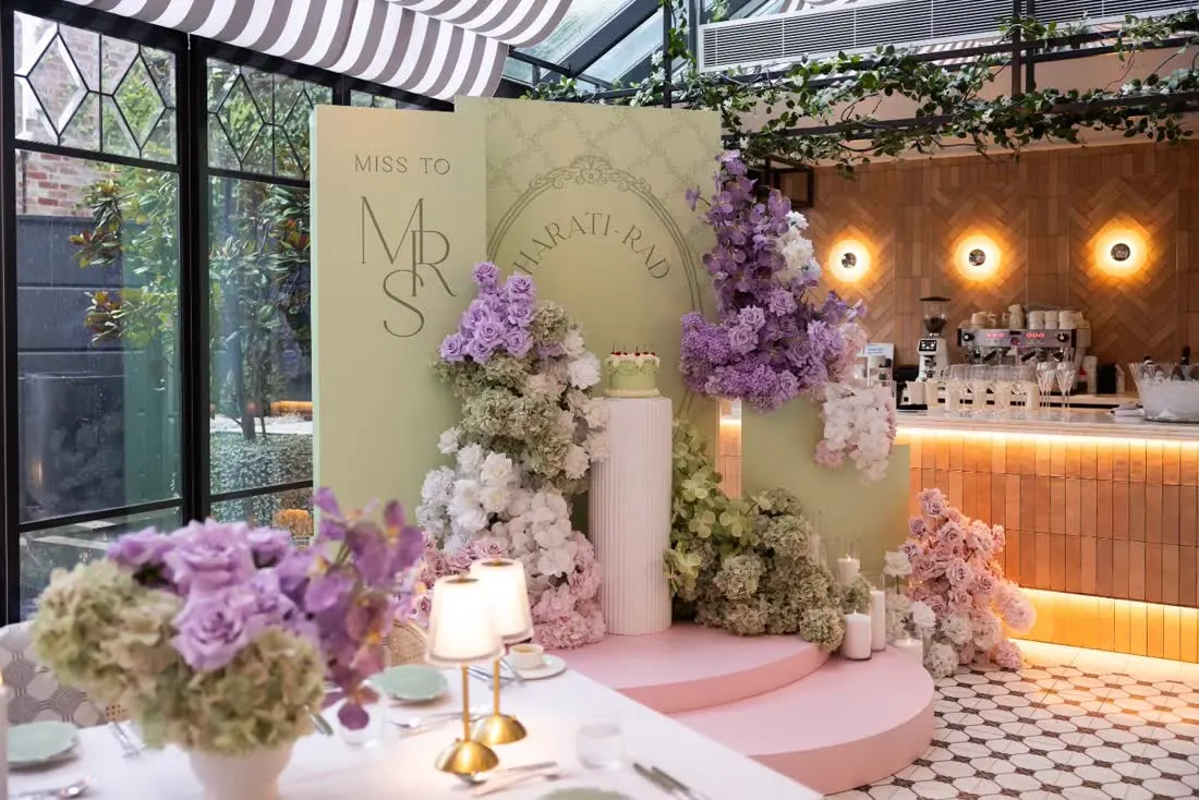 Neutral styled celebration with printed arch backdrops