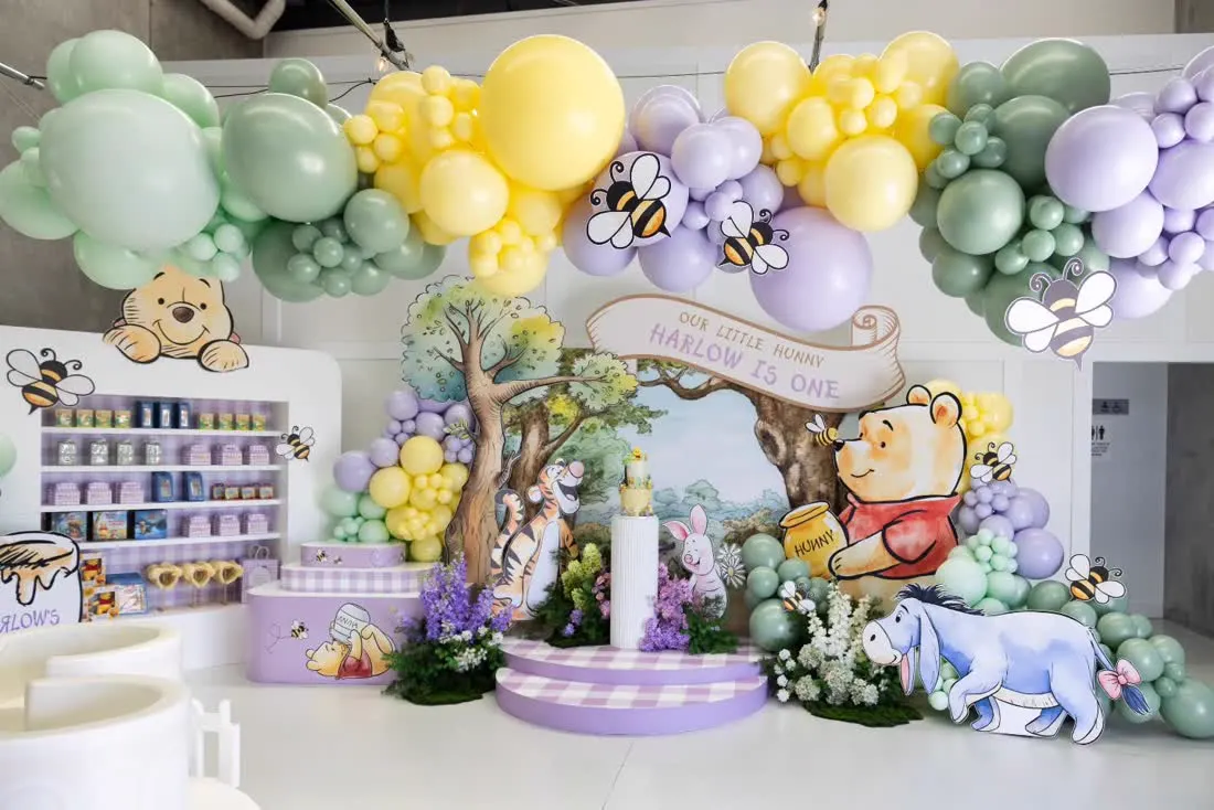 Storybook character cutouts and printed backdrop at a party