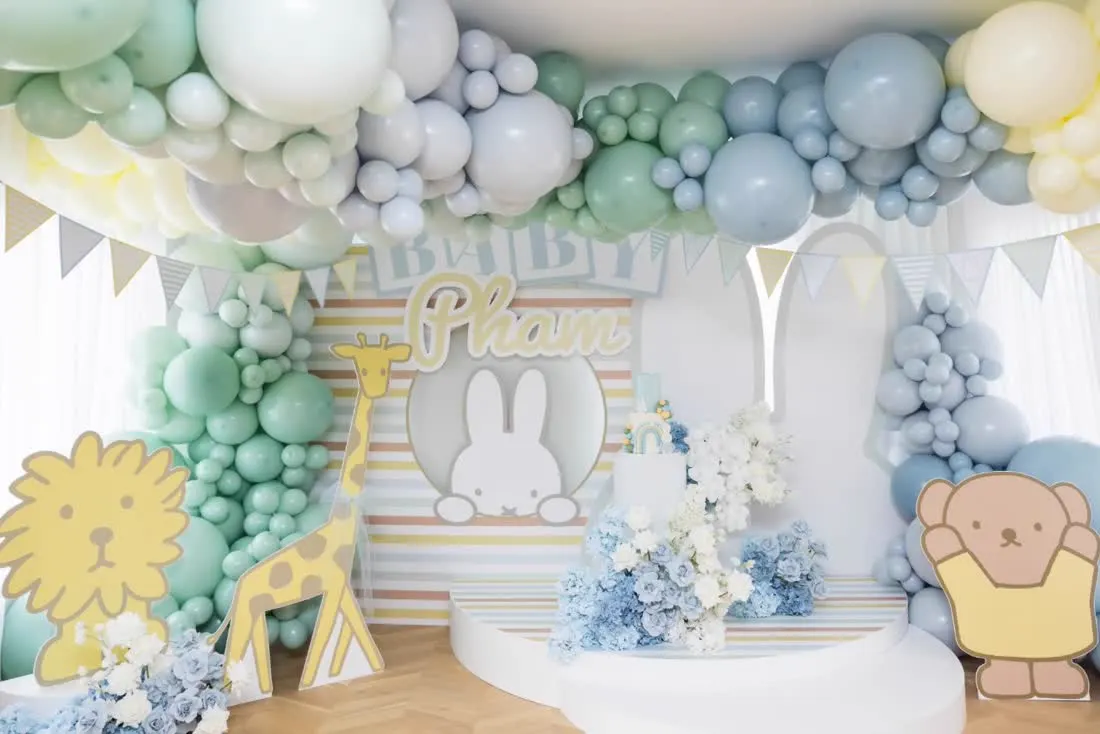 Pastel animal themed party backdrop with character cutouts