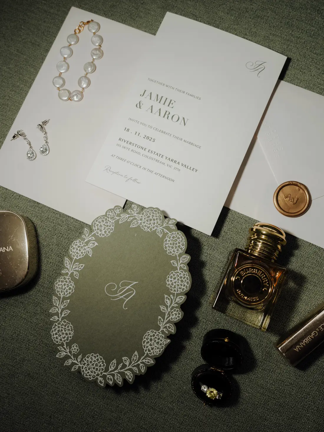Printed wedding invitation suite in sage green with a wax seal and monogram detail card